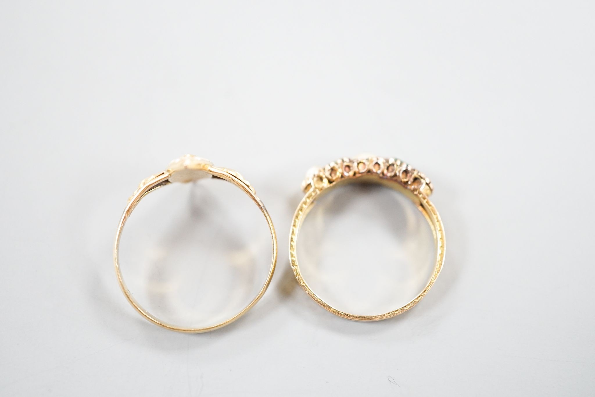 A Victorian 15ct gold, emerald and split pearl set five stone half hoop ring, size M, gross 1.9 grams and an early 20th century yellow metal and seed pearl set dress ring, size O, gross 1.7 grams.